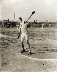 Martin Sheridan de la Greater New York Irish Athletic Association lançant le disque aux Jeux Olympiques de 1904